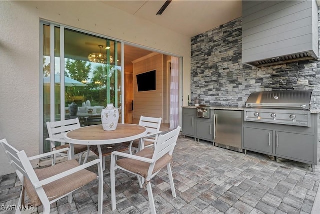 kitchen featuring refrigerator and gray cabinetry