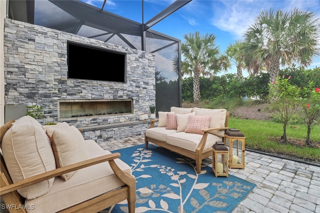 view of patio / terrace with an outdoor living space with a fireplace