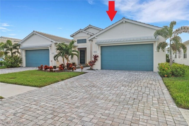 view of front facade featuring a garage and a front lawn