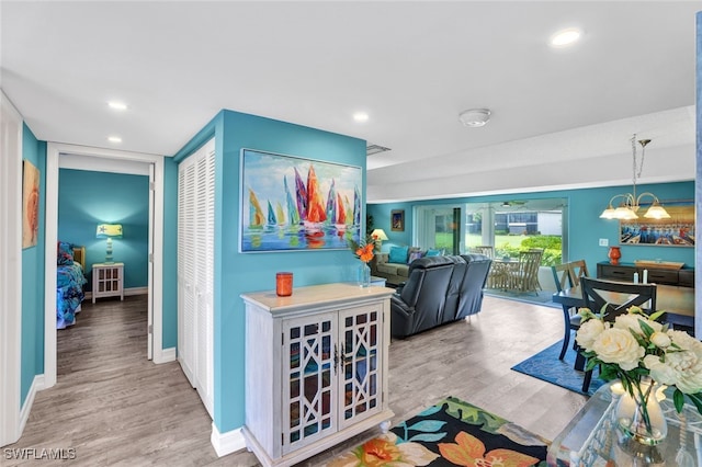 interior space featuring light hardwood / wood-style floors and an inviting chandelier