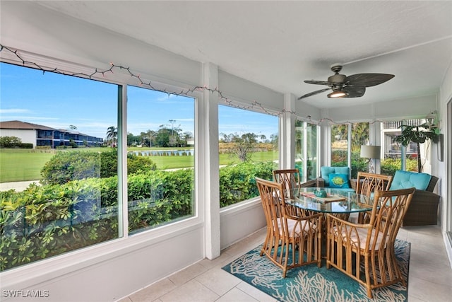 sunroom / solarium featuring ceiling fan