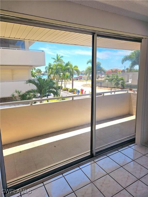 doorway to outside with tile patterned flooring