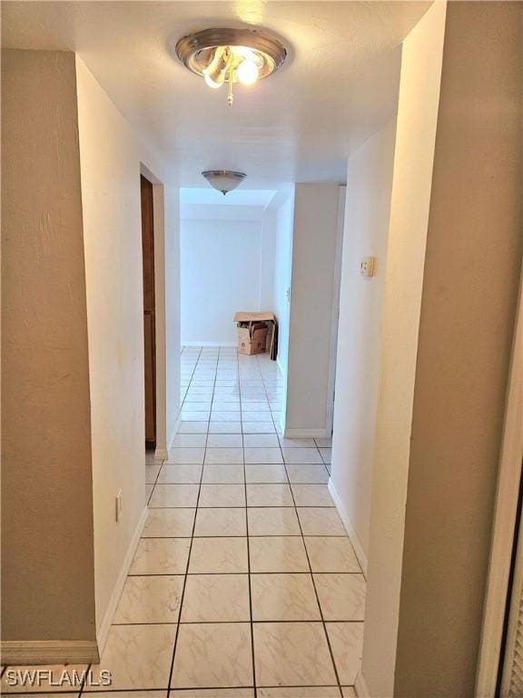 corridor with light tile patterned floors