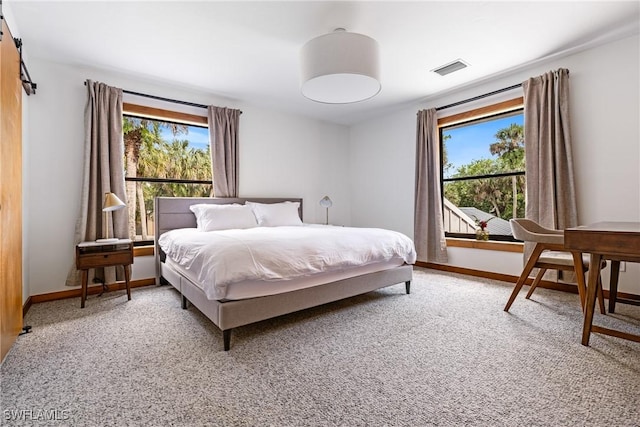 carpeted bedroom with visible vents, multiple windows, and baseboards