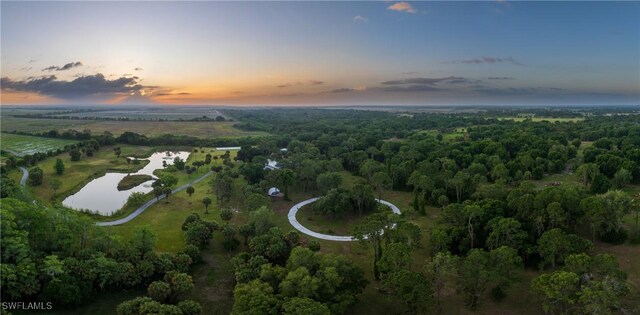 aerial view at dusk with a water view