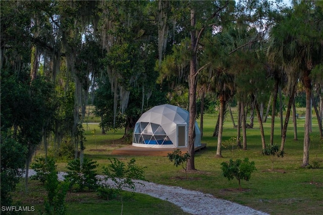 view of home's community featuring an outdoor structure and a yard