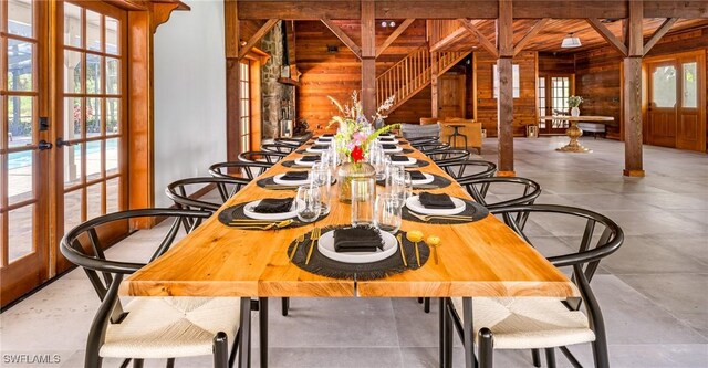 dining area with beam ceiling, french doors, and a healthy amount of sunlight