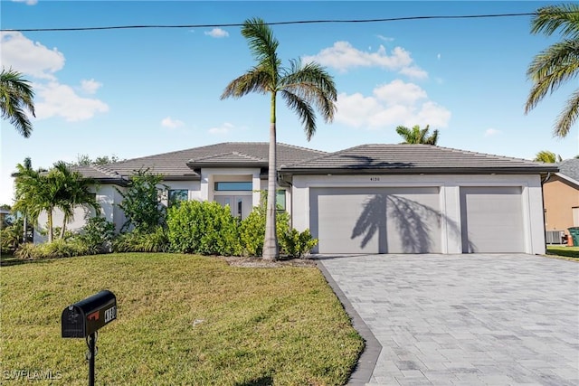 view of front facade with a front yard and a garage