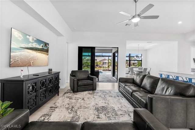 living room with ceiling fan and light hardwood / wood-style floors