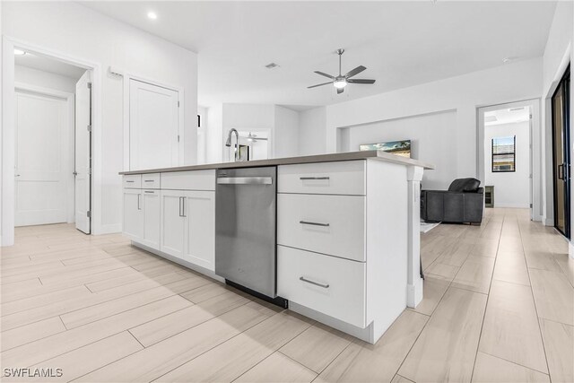 kitchen with white cabinetry, dishwasher, ceiling fan, sink, and light hardwood / wood-style flooring