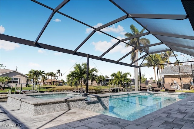 view of swimming pool with an in ground hot tub, a patio area, and a lanai