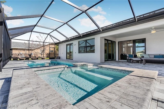 view of pool with an outdoor hangout area, a patio area, ceiling fan, and a lanai