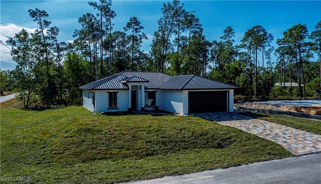 view of front facade with a garage and a front lawn