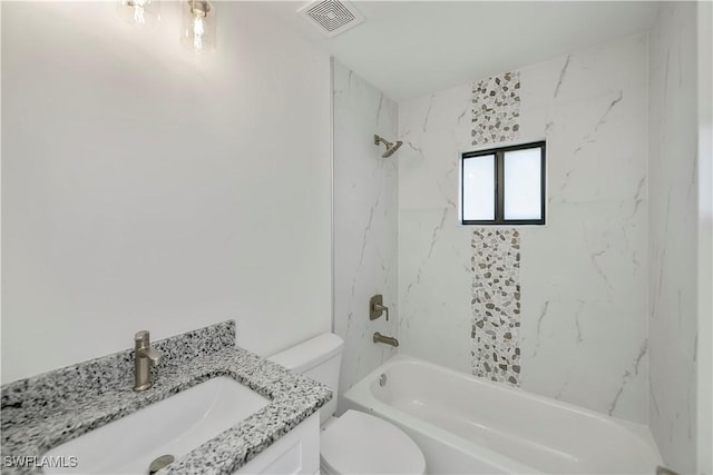 full bathroom featuring vanity, toilet, and tiled shower / bath combo