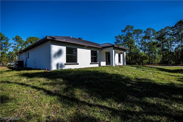 view of side of home featuring a yard