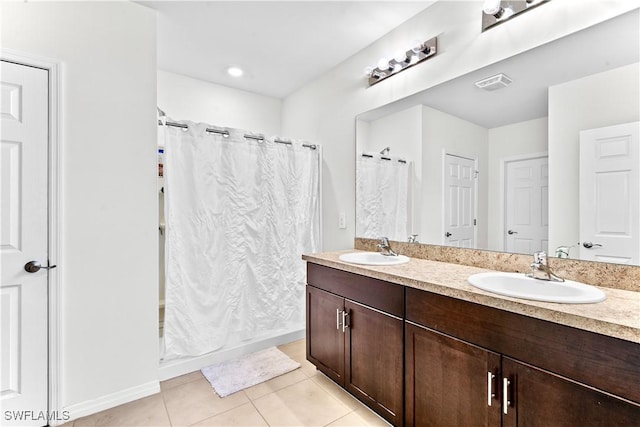 bathroom featuring tile patterned flooring and vanity