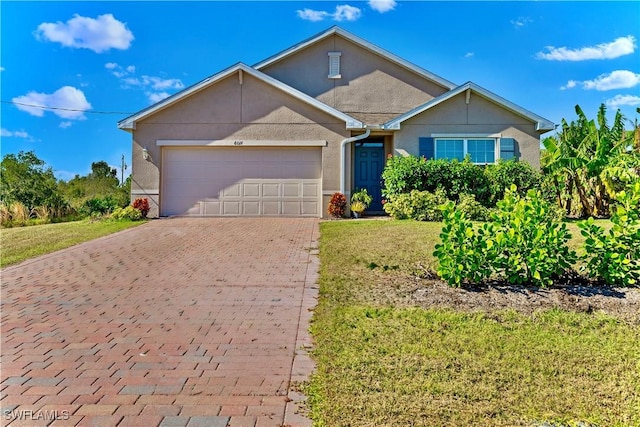 view of front of property with a front yard and a garage