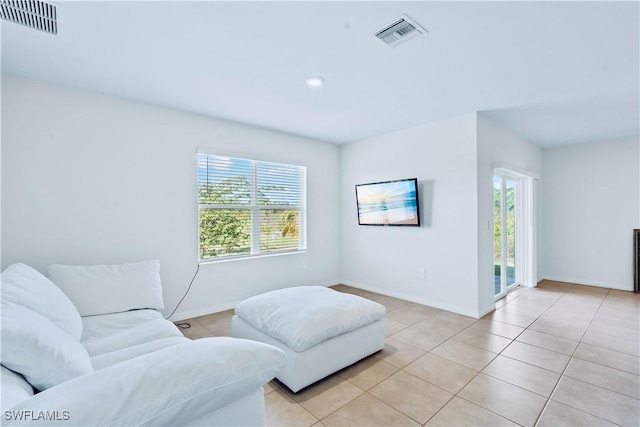 living area with a healthy amount of sunlight and light tile patterned flooring