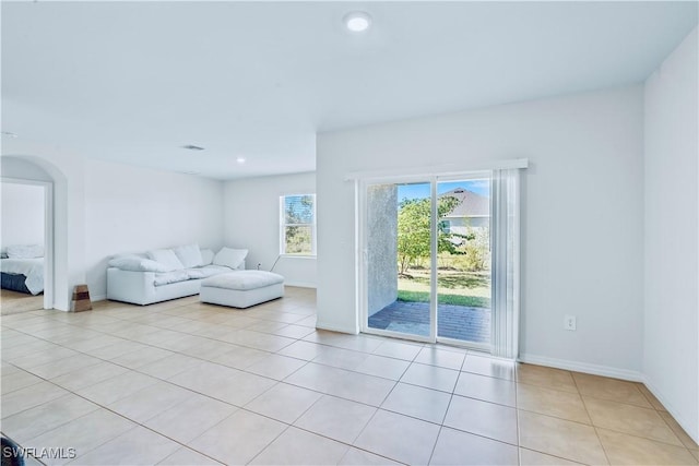 unfurnished living room featuring light tile patterned flooring