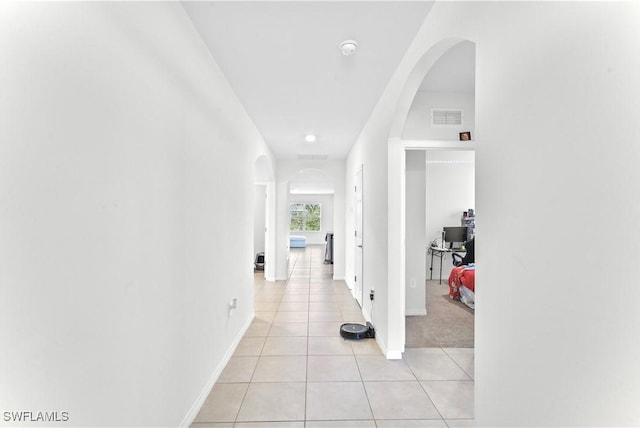 corridor featuring light tile patterned flooring