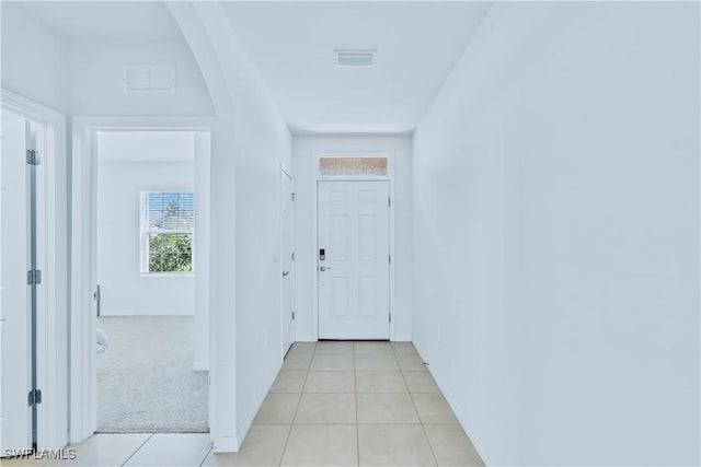 hall featuring light colored carpet