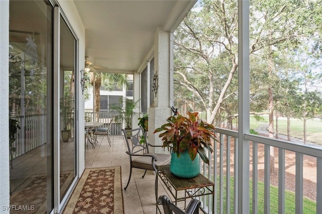 unfurnished sunroom with ceiling fan