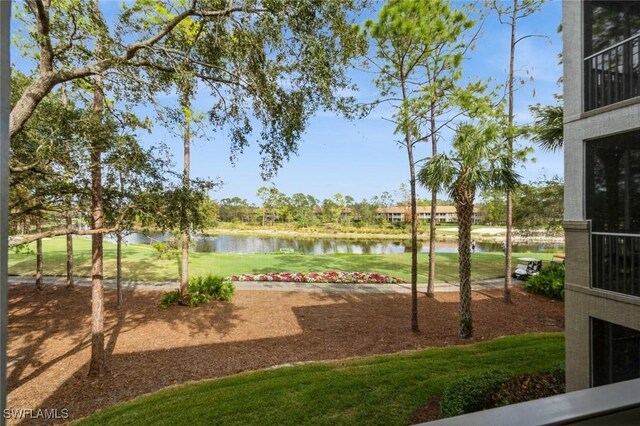 view of play area featuring a water view and a lawn