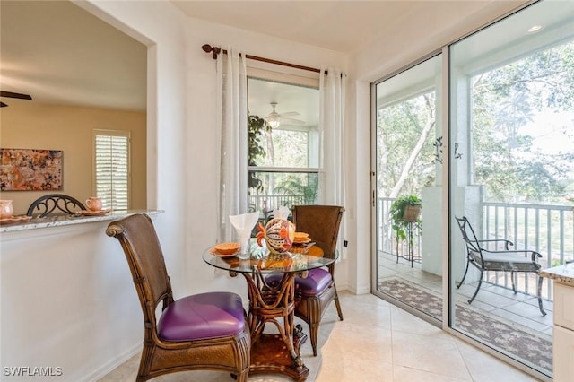 doorway to outside with ceiling fan and light tile patterned flooring