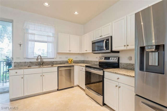 kitchen with white cabinets, a healthy amount of sunlight, sink, and stainless steel appliances