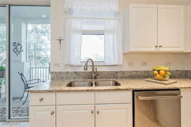 kitchen with white cabinetry, stainless steel dishwasher, and a wealth of natural light