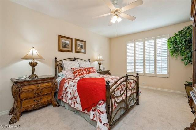 bedroom featuring light colored carpet and ceiling fan