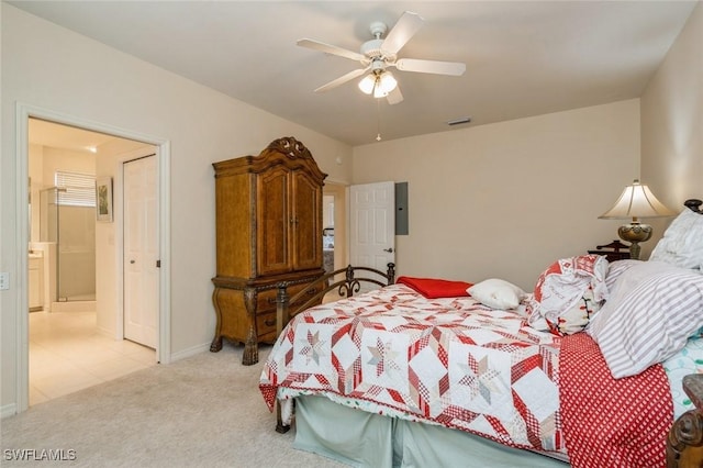 bedroom featuring ceiling fan, light carpet, and connected bathroom