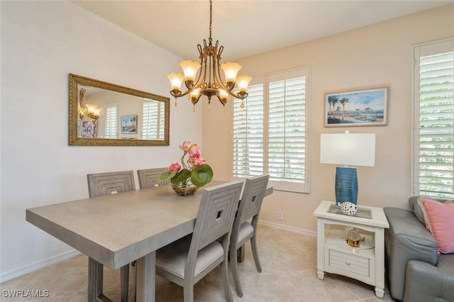 dining area with light tile patterned floors and a notable chandelier