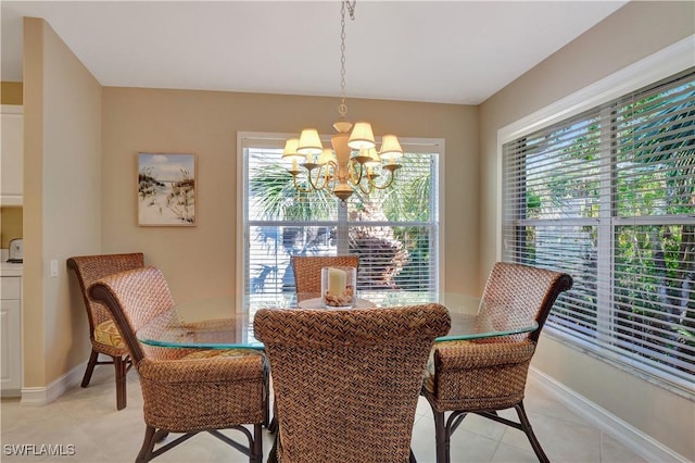 tiled dining area with an inviting chandelier