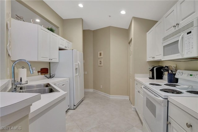 kitchen featuring sink, white cabinets, white appliances, and light tile patterned floors