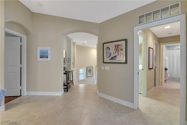 hall featuring light tile patterned flooring