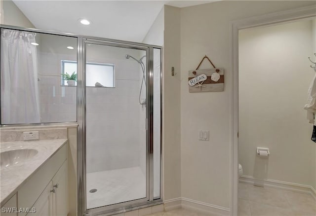 bathroom with tile patterned floors, vanity, an enclosed shower, and toilet