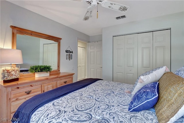 bedroom with multiple closets and ceiling fan