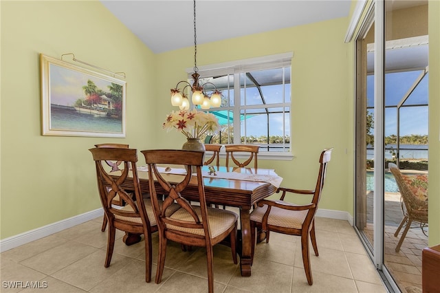 tiled dining space featuring an inviting chandelier