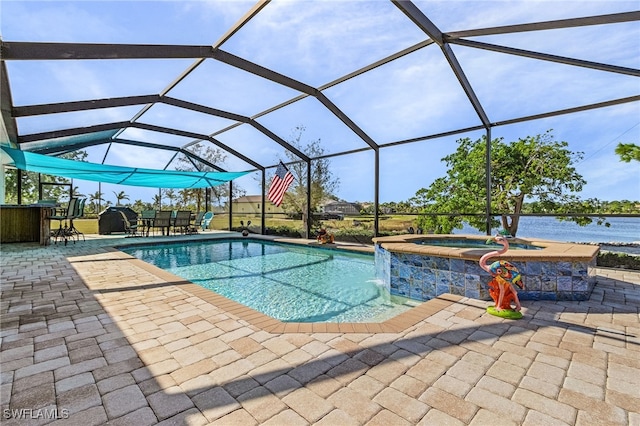 view of pool with a patio, a lanai, an in ground hot tub, and a water view