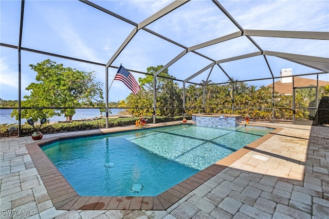 view of swimming pool with a lanai, a patio area, and a water view