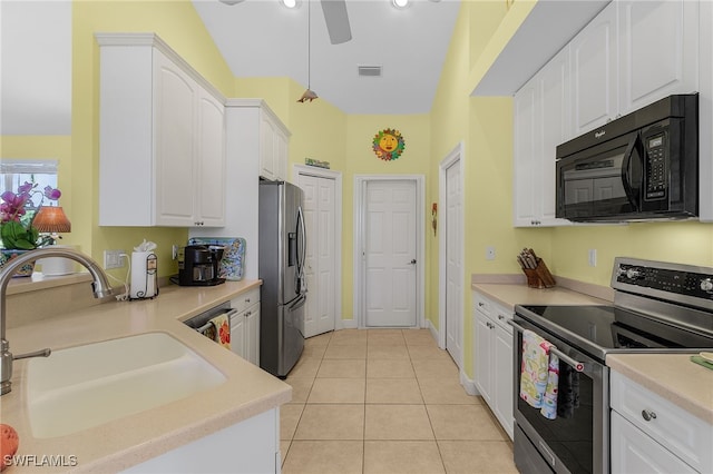 kitchen featuring white cabinetry, sink, light tile patterned flooring, and appliances with stainless steel finishes