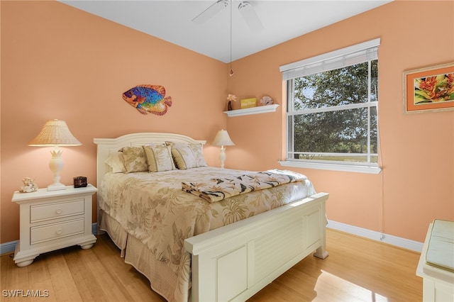 bedroom with light hardwood / wood-style floors and ceiling fan