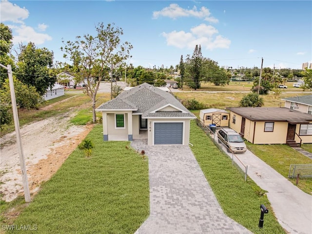 view of front of property with a front lawn and a garage