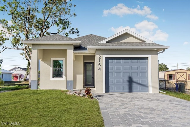 view of front of home featuring a front yard and a garage