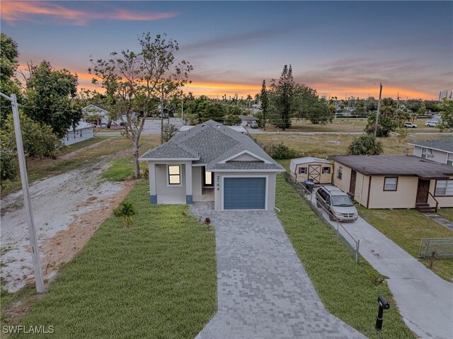 view of front of house with a garage and a lawn