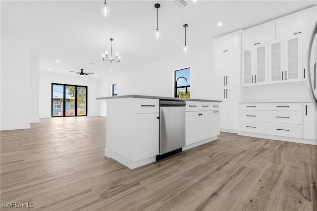 kitchen featuring stainless steel dishwasher, ceiling fan, light hardwood / wood-style flooring, white cabinets, and hanging light fixtures