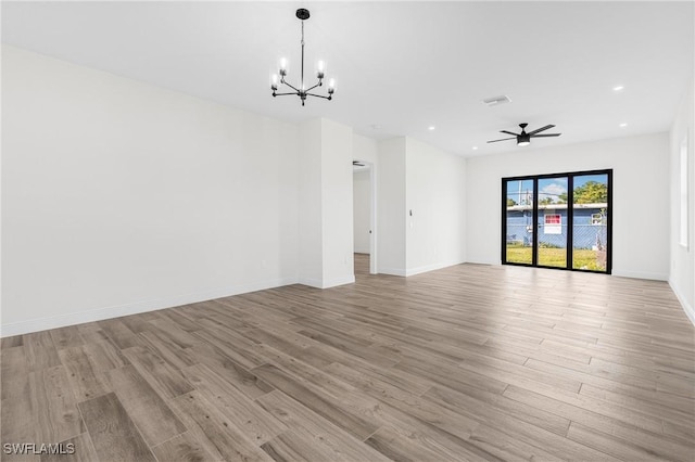 interior space with light hardwood / wood-style flooring and ceiling fan with notable chandelier