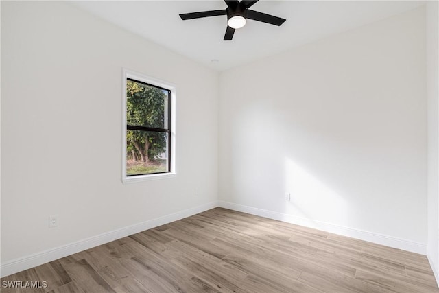 spare room with light hardwood / wood-style floors and ceiling fan