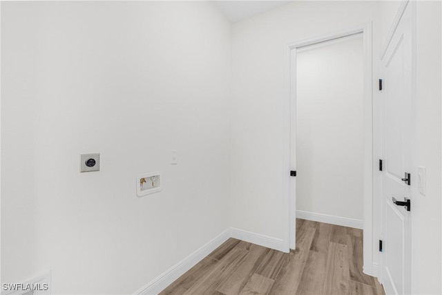 laundry room featuring electric dryer hookup, hookup for a washing machine, and light hardwood / wood-style floors